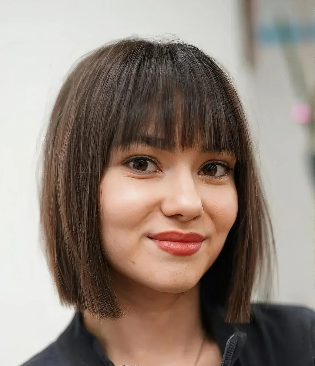 Classic fringe paired with an Italian bob and a stylish natural brown shade are a timeless and chic combo.