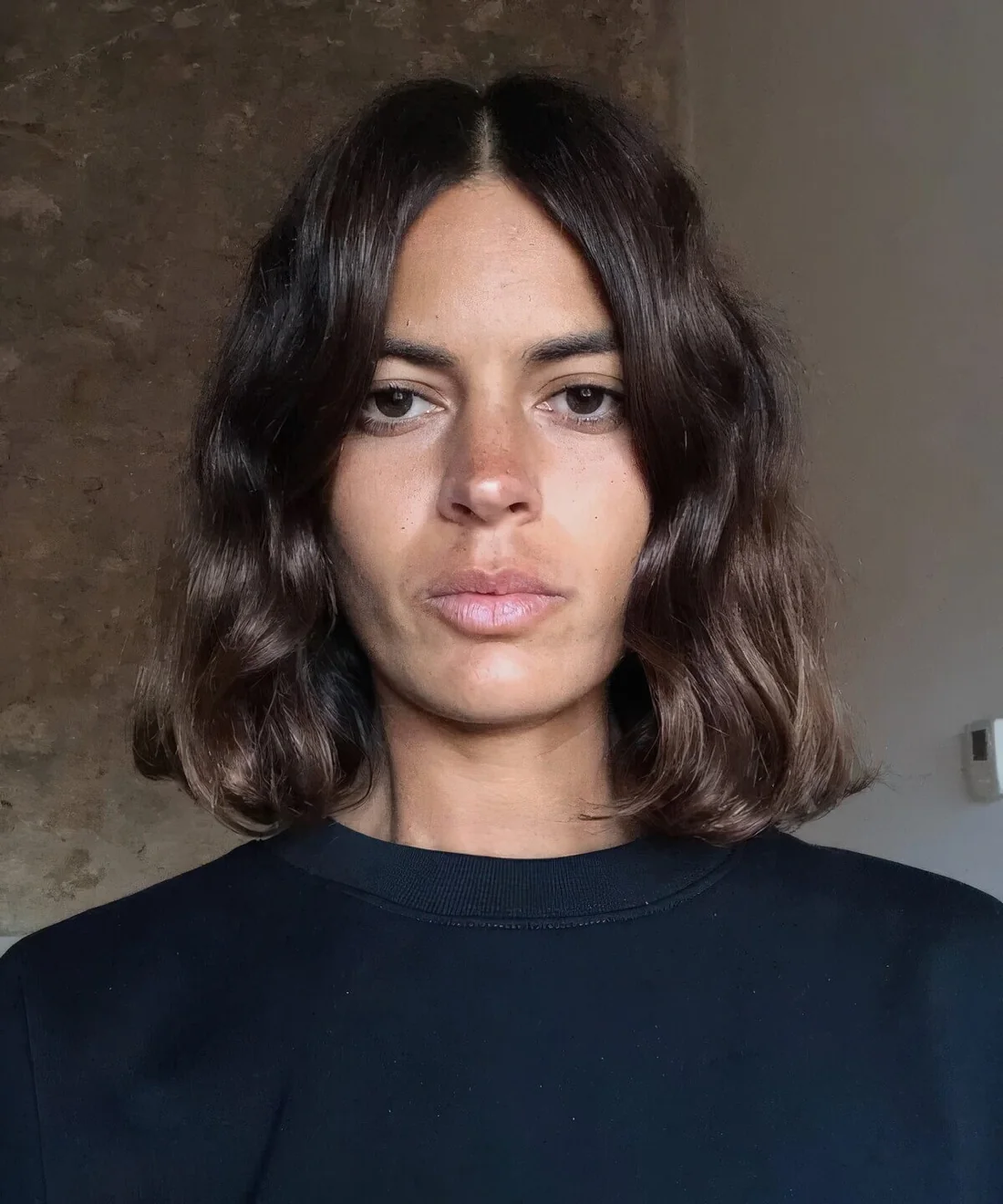 Rich brown wavy Italian bob with center part.