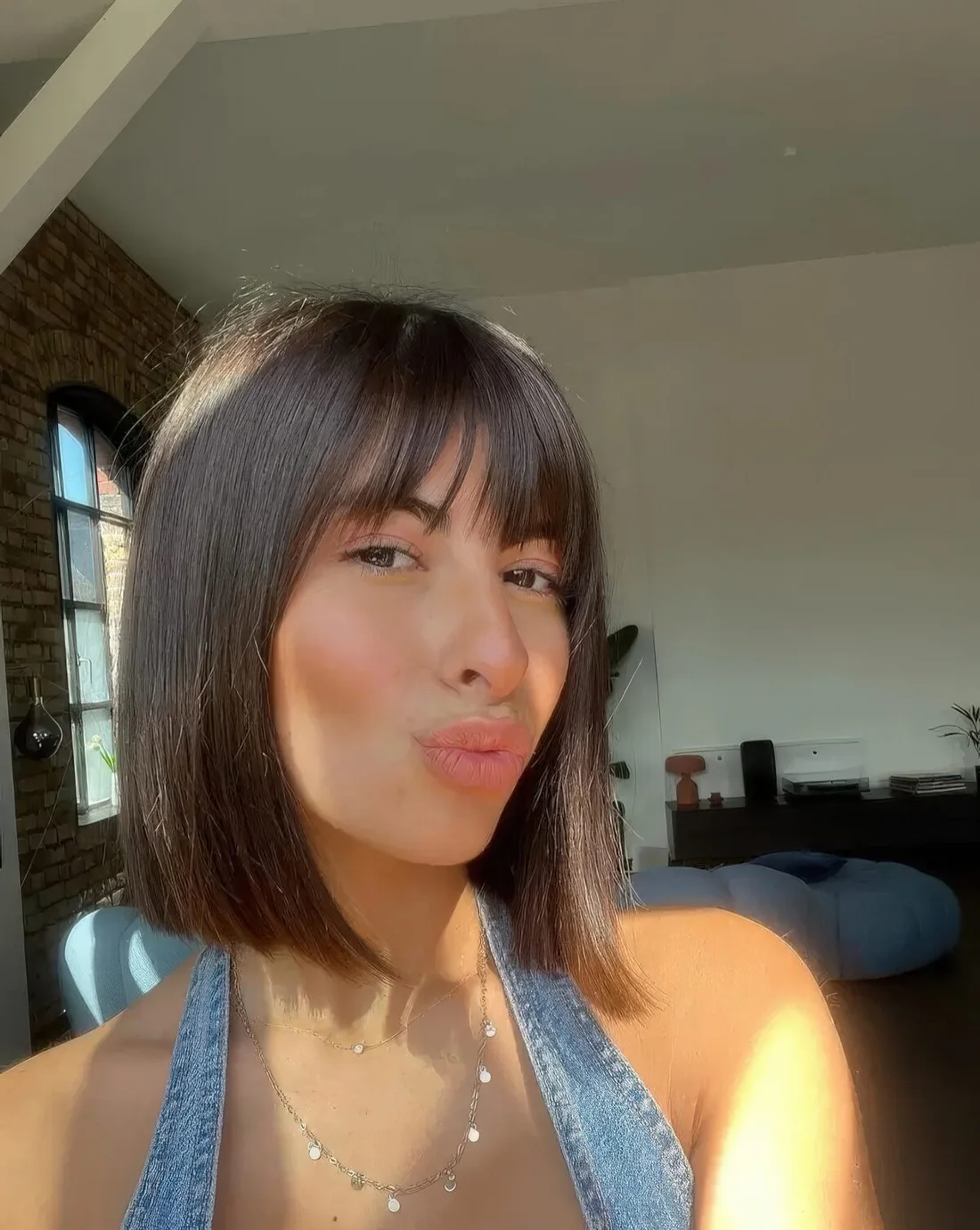 Over the shoulder haircut with wispy bangs.