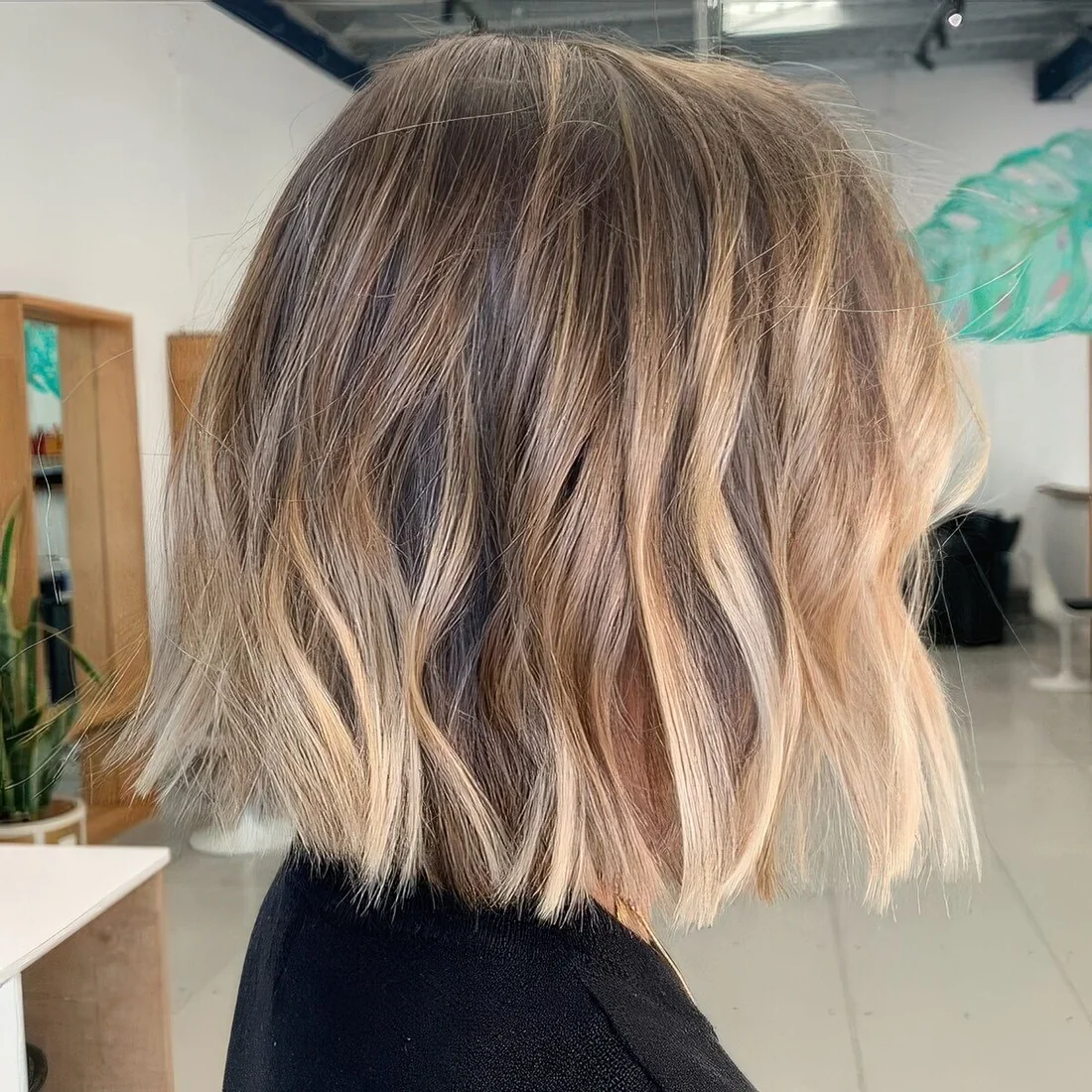 Bronde blunt bob with waves and a dark root.