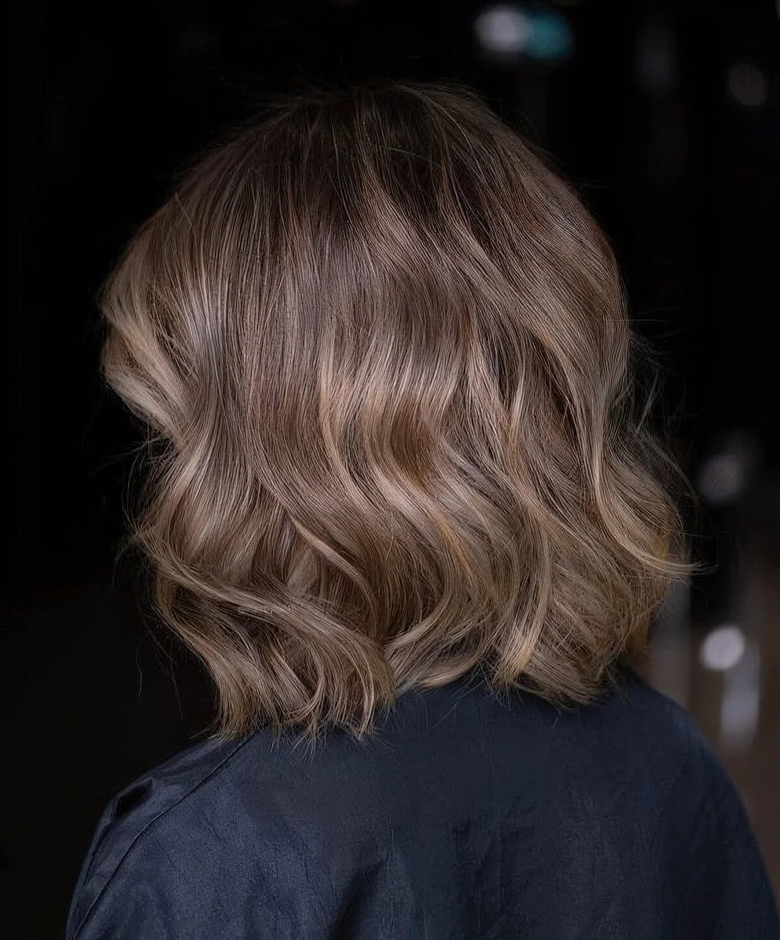 Long bronde bob with golden blonde highlights and waves.