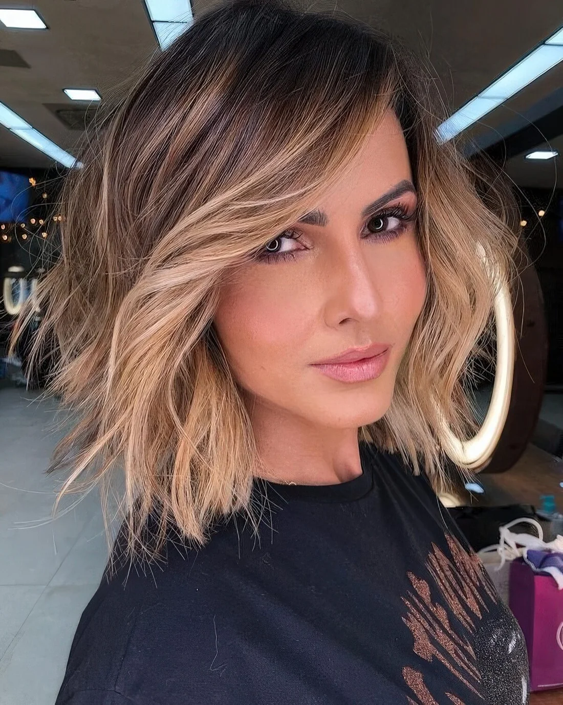 Long dark brunette bob with soft blonde balayage and money piece to highlight the face.