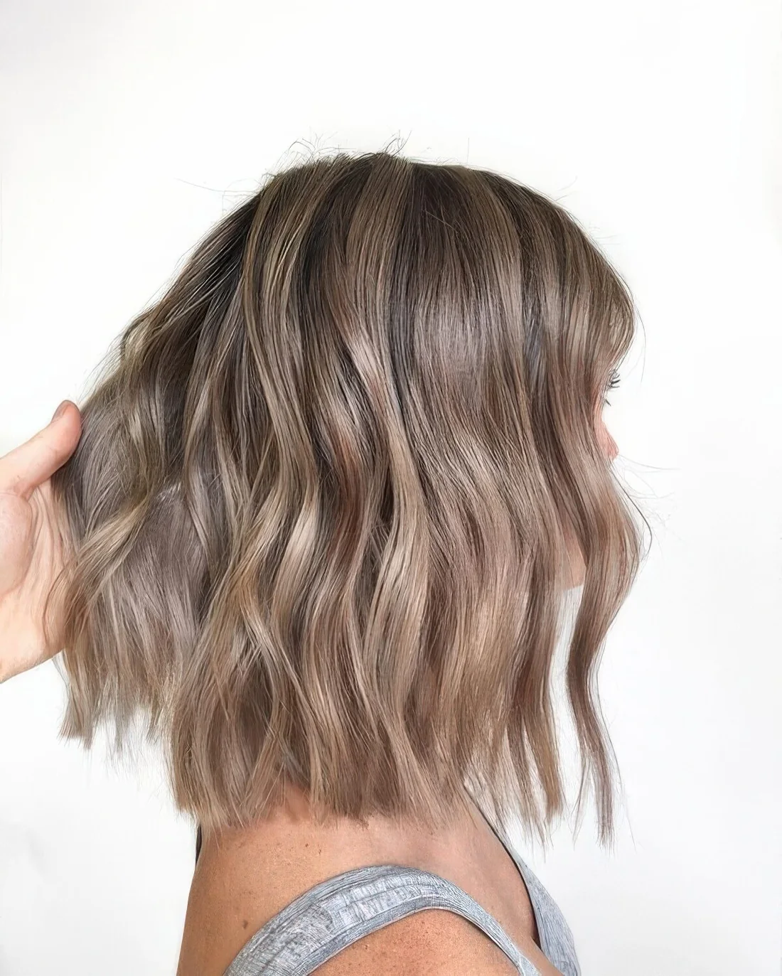 Long wavy bronde bob with a darker root.