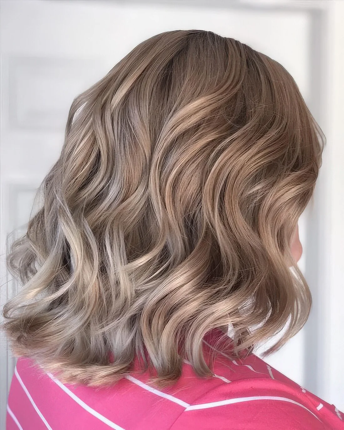 Soft and subtle bronde long bob with waves and volume.