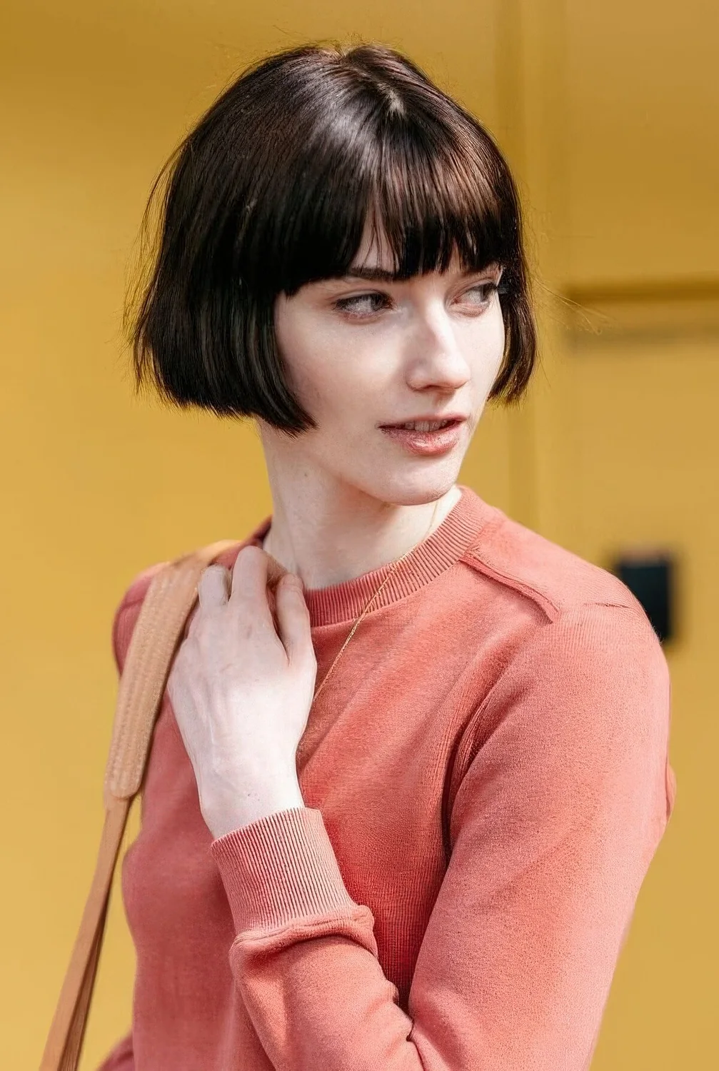 Brown ear-length bob with classic bangs and a bit of texture.