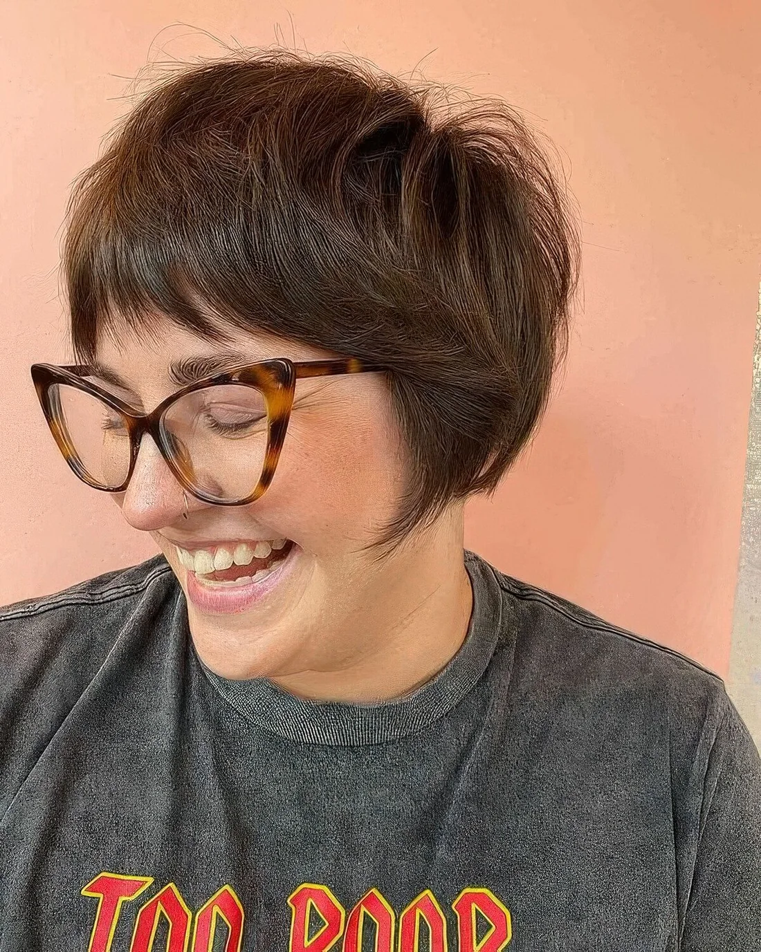Photo showing short bob with wispy bangs, with the hairstyle clearly visible.