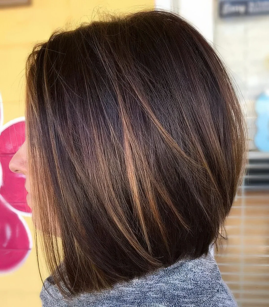 Dark brunette long bob with caramel balayage, such highlights give interest to the look.