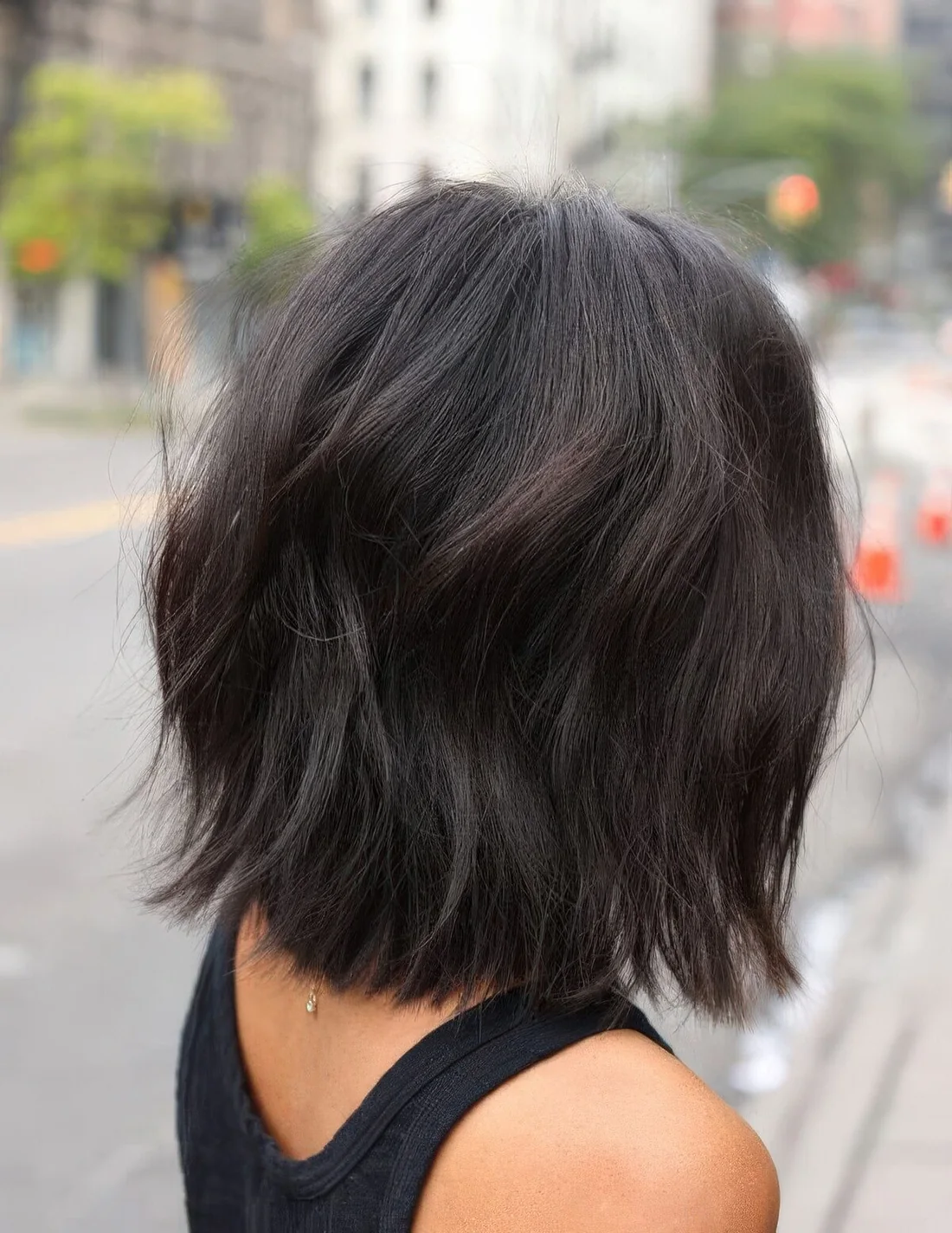 Dark brunette long bob with volume, dimension and waves.