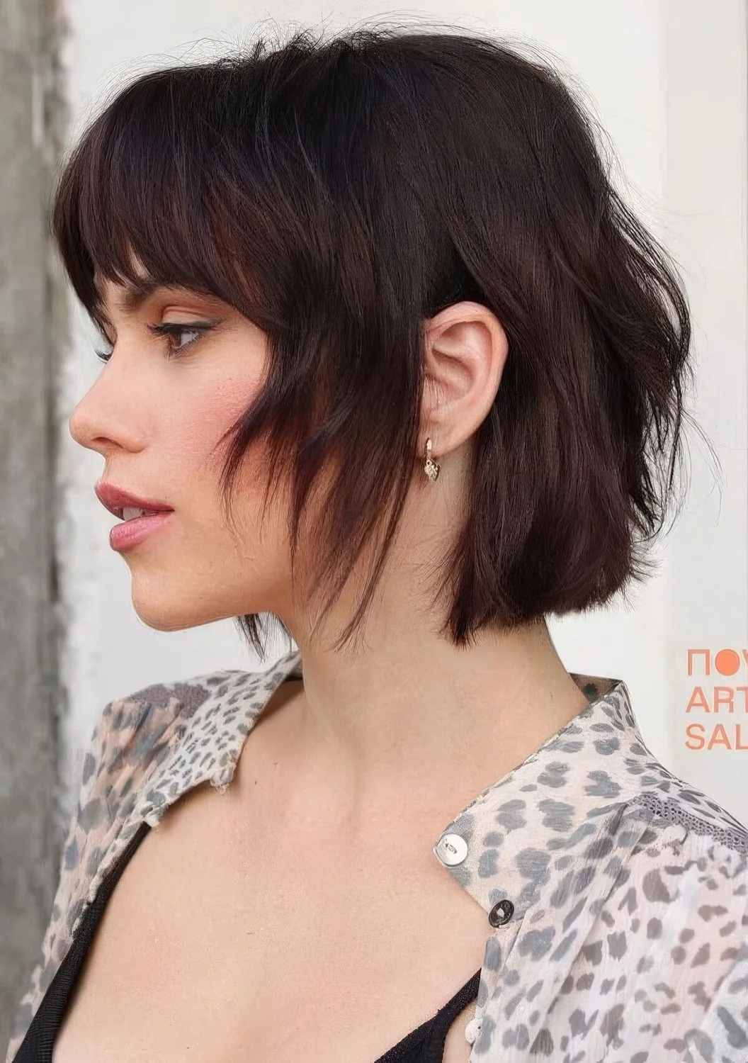 Dark chestnut shaggy and layered short bob with bottleneck bangs.