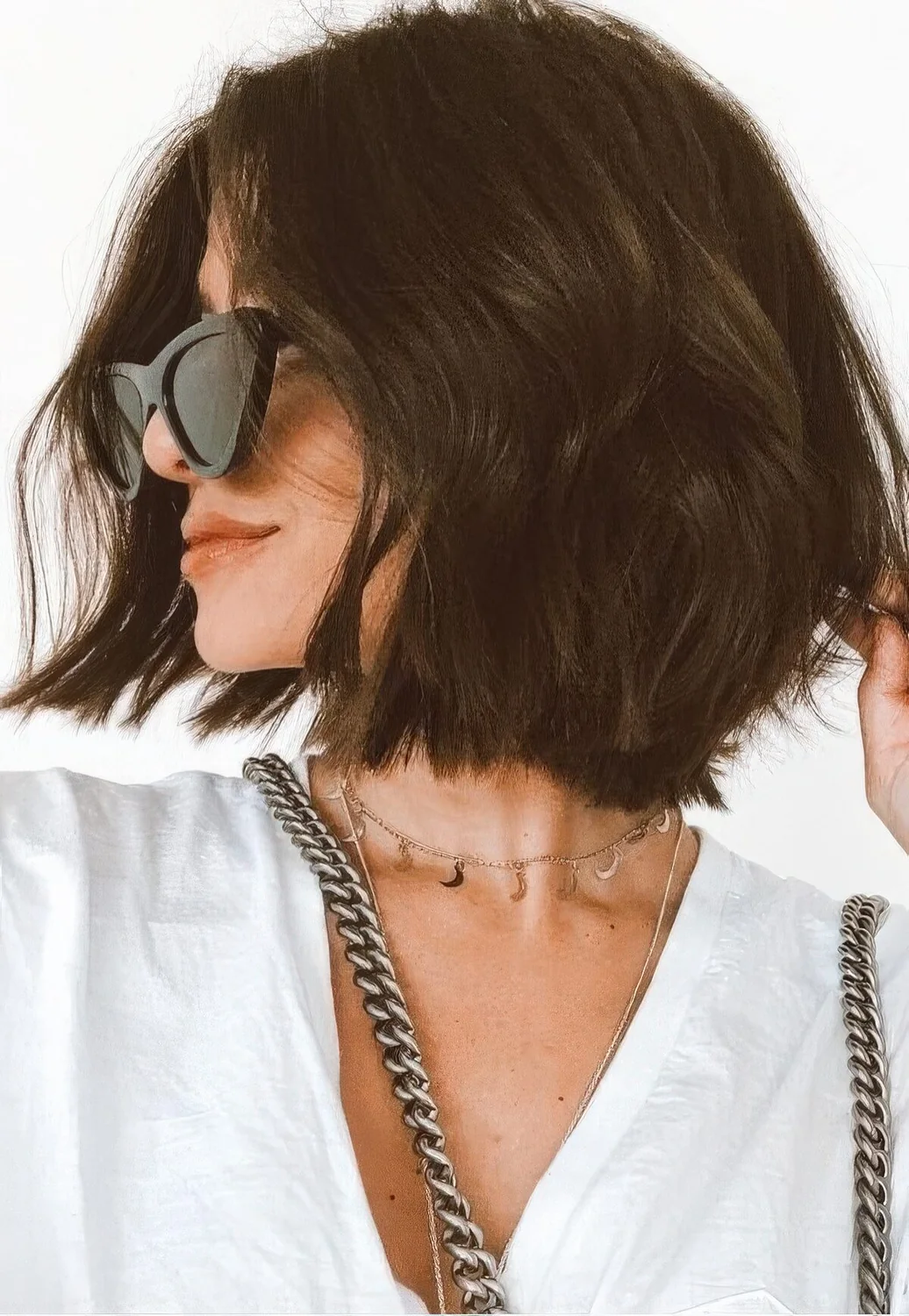 Photo showing dark wavy layered bob, with the hairstyle clearly visible.