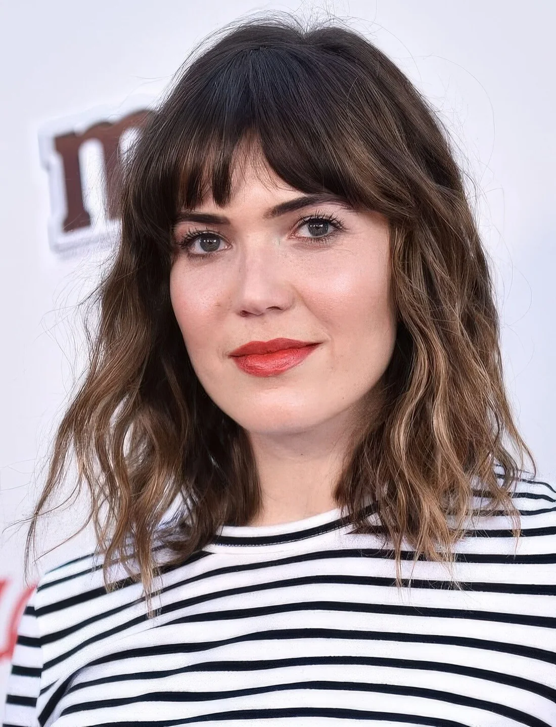 Long dark brunette bob with bronde balayage, bottleneck bangs and waves.