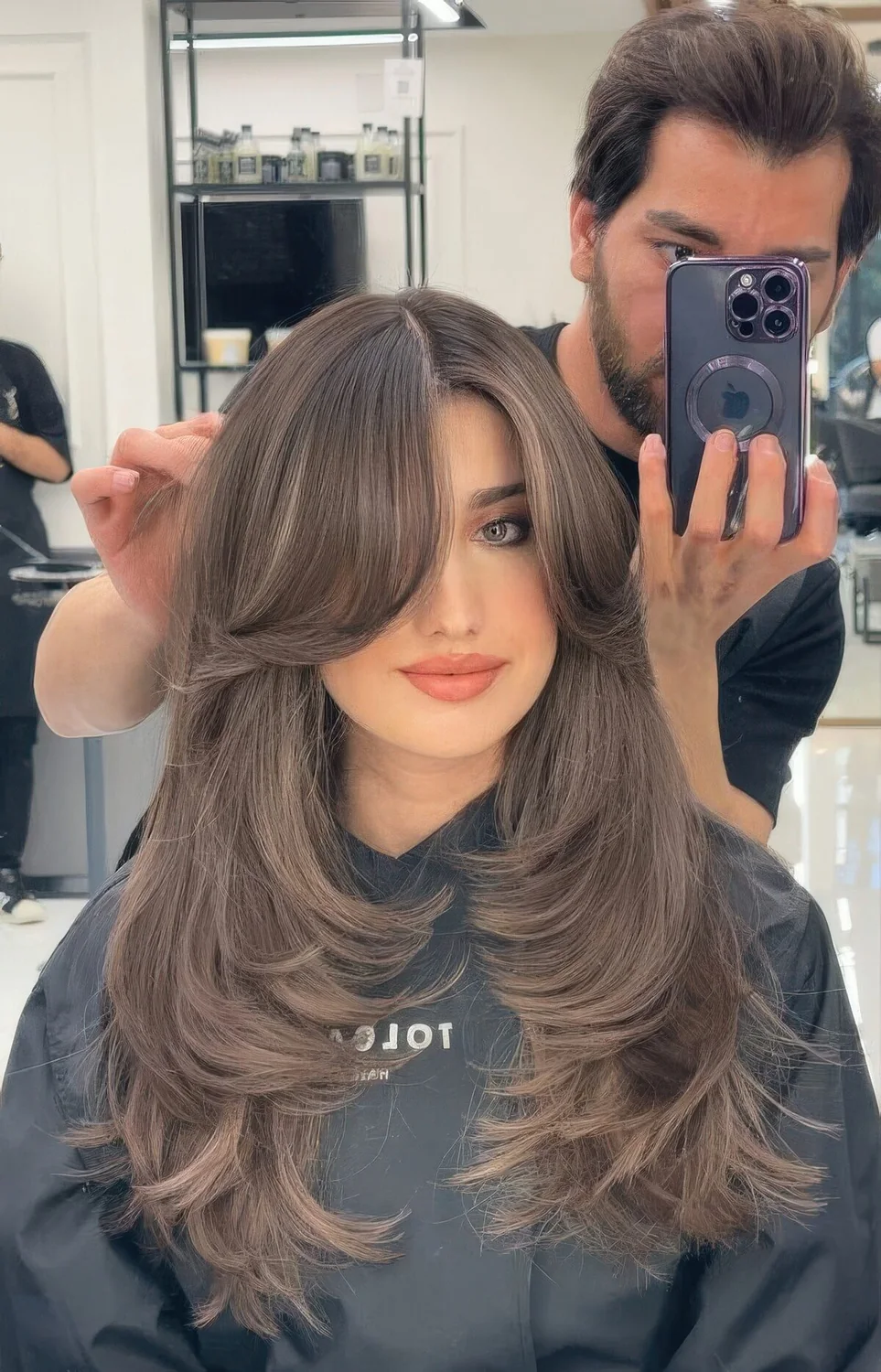 Jaw doppring long butterfly brunette hairstyle with long curtain bangs.