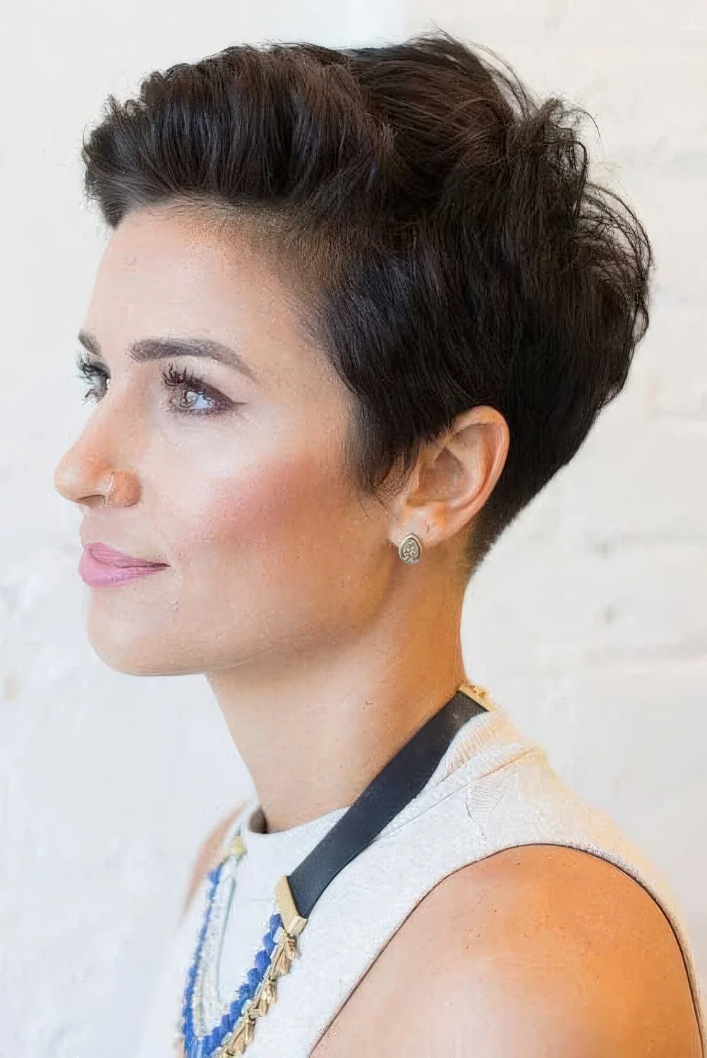 Dark brunette pixie haircut with a lot of volume.