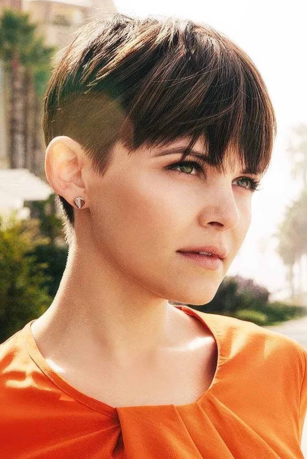 Dark brunette pixie haircut with straight hair and long fringe.
