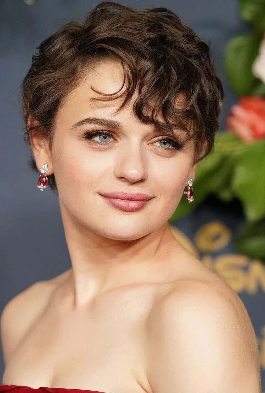 Brown wavy bixie with side part, long side bangs.