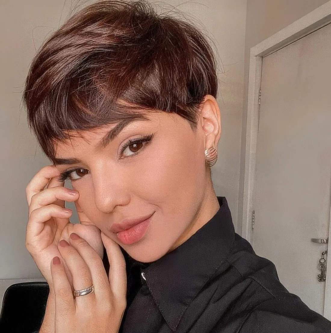 Layered pixie haircut in a rich brown shade, with soft layers.