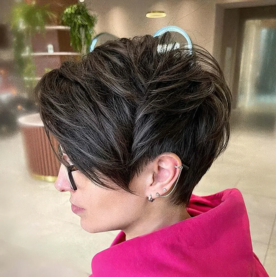 Long layered brunette pixie cut features movement and texture, try it longer on the top and shorter on the sides.