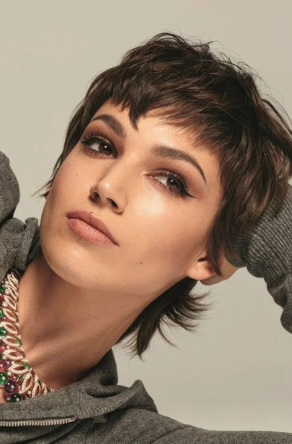 Short brunette mullet with bangs and a bit of volume.