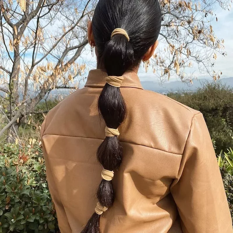 chest straight chestnut ponytail shown as a bubble braid ponytail hairstyles idea, featuring straight texture
