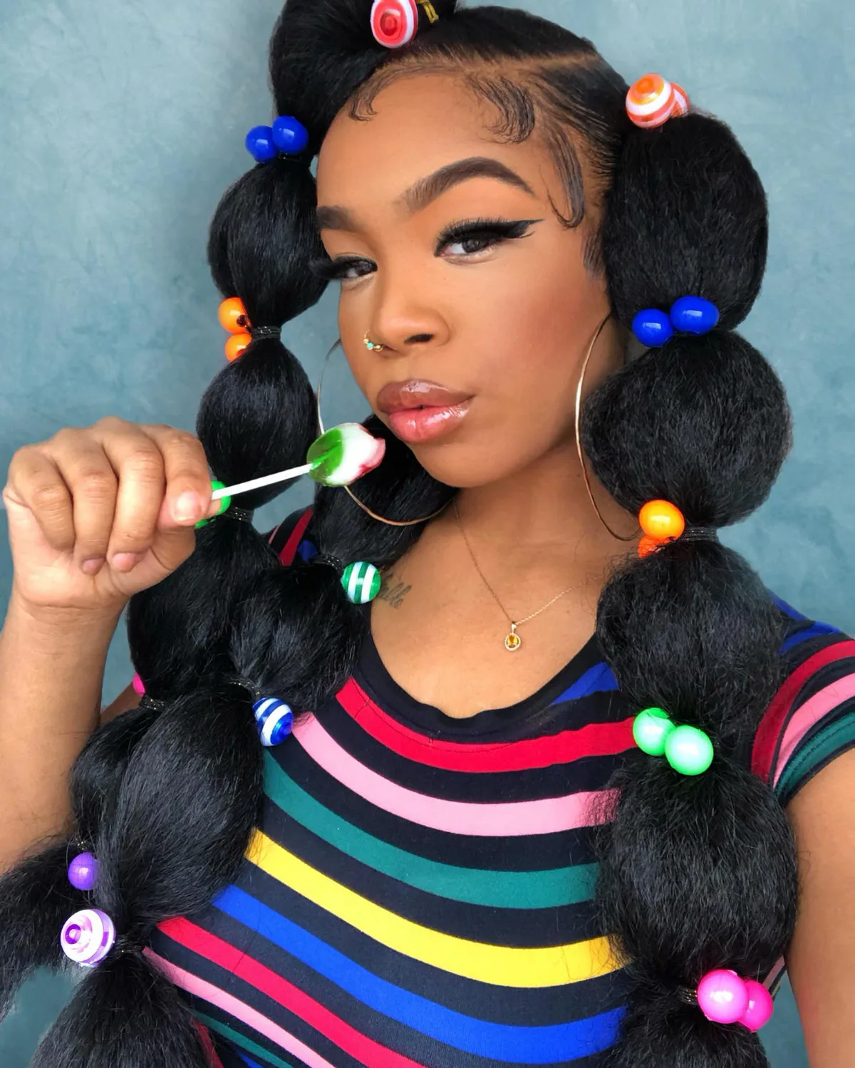 chest coily black ponytail shown as a bubble braid ponytail hairstyles idea