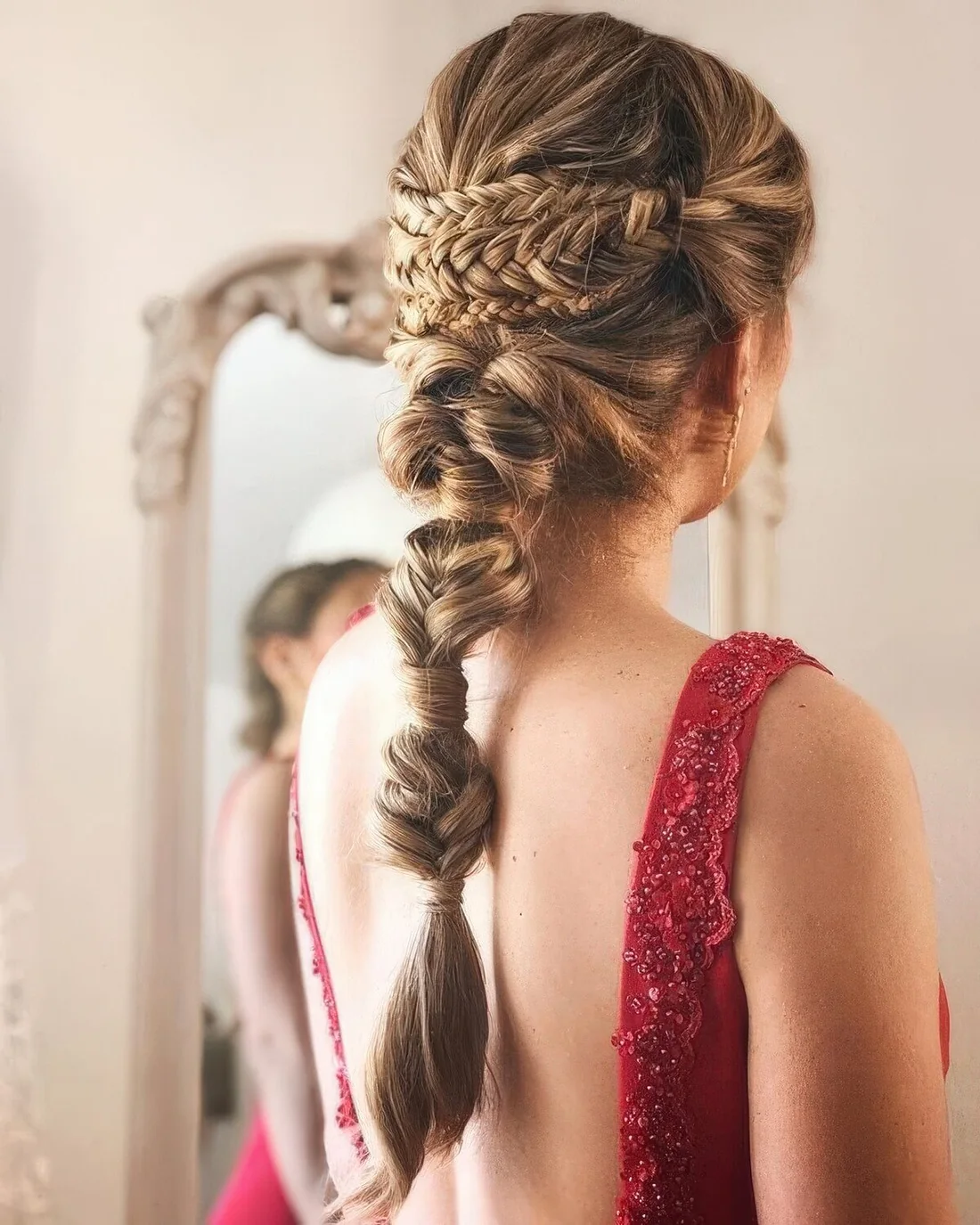 Complicated wedding hairstyle with a triple braided halo and a fishtail plus bubble braid plus a volume on top.