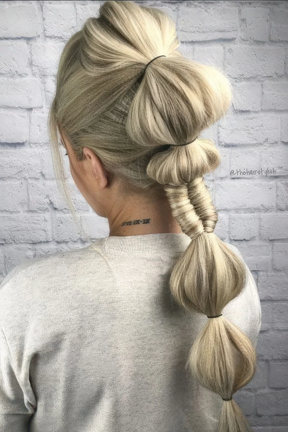 Creative high ponytail with a volume on top and a bubble braid with a wrapped touch.