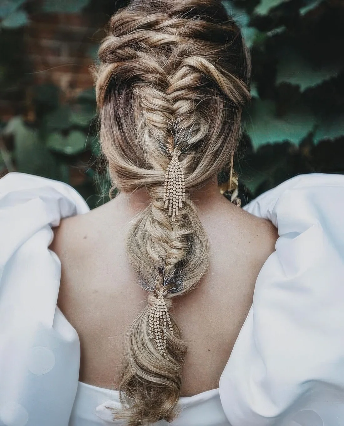 Wedding hairstyle with twisted halos, a fishtail bubble braid and embellishments.