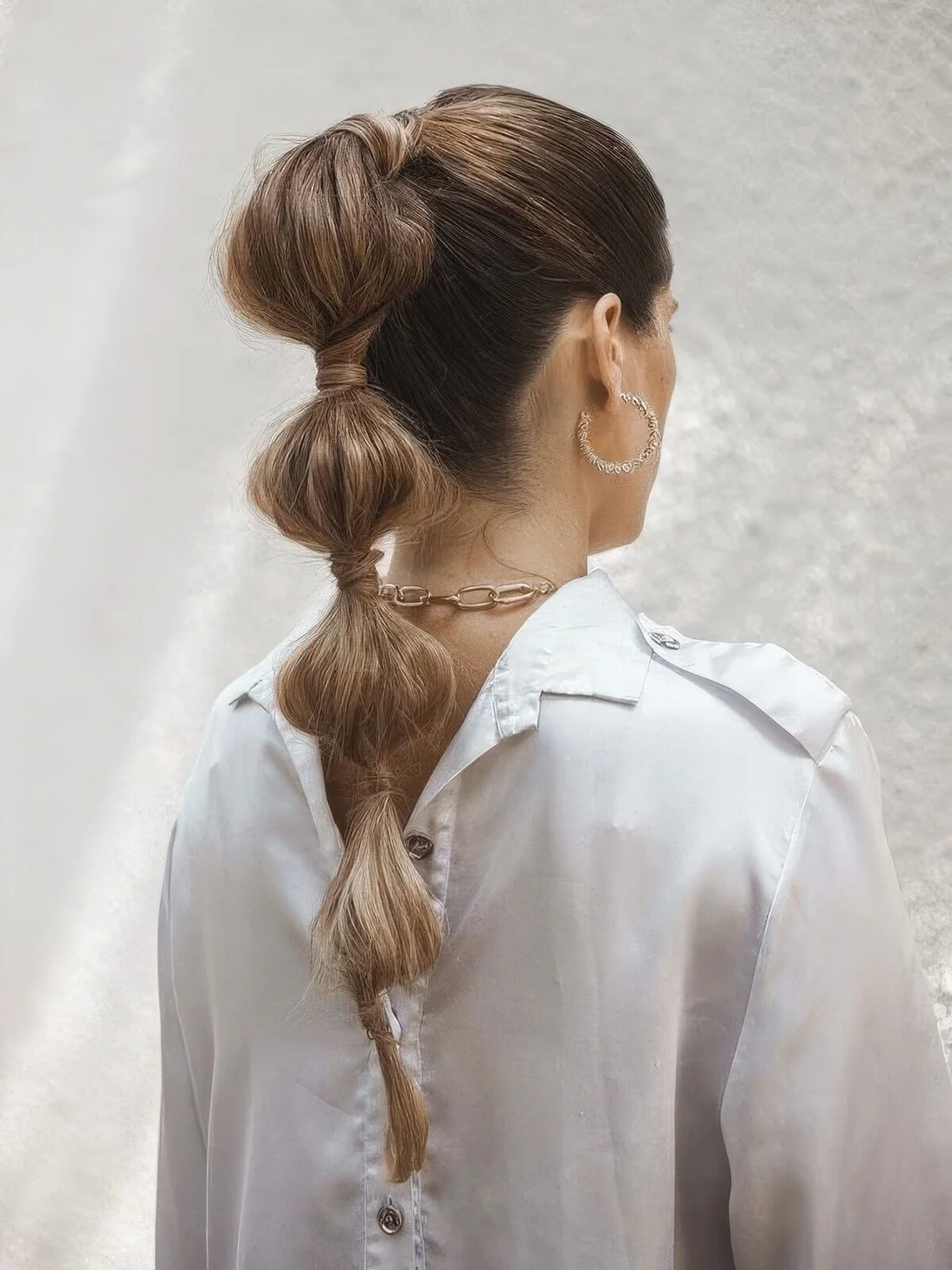 High bubble braid with a sleek yet volumetric top.