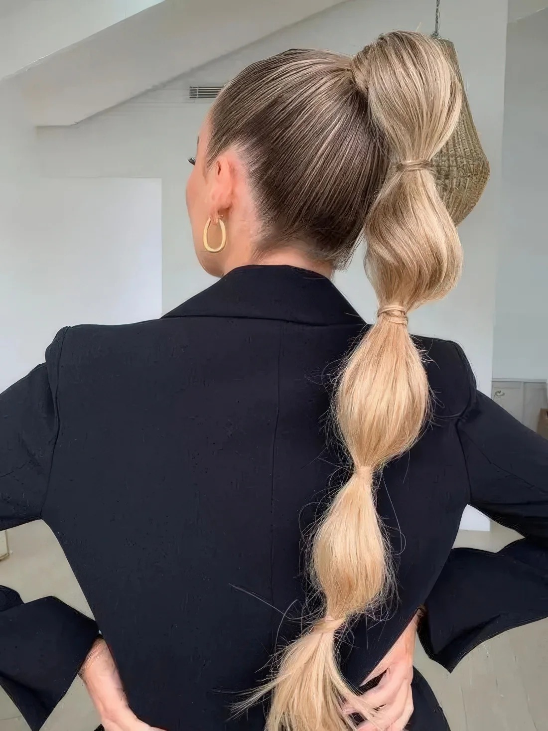 High bubble ponytail with a sleek top and sides.