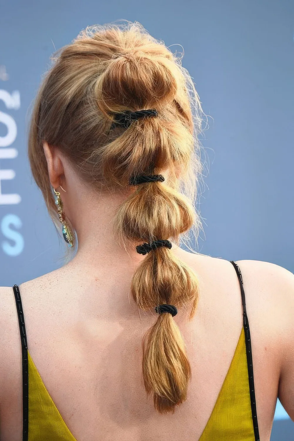 High bubble ponytail with a volume on top and face-framing hair plus black elastics.