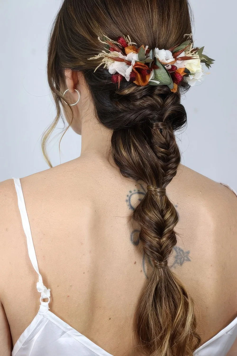 Wedding hairstyle with a fishtail and bubble braid plus some faux blooms for the fall.