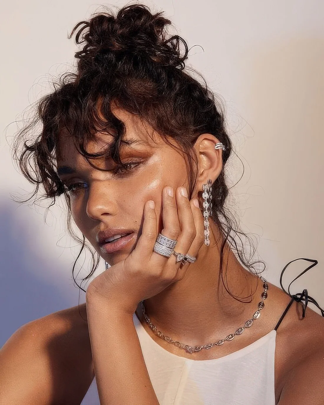 Curly top knot and a bit of curly bangs.