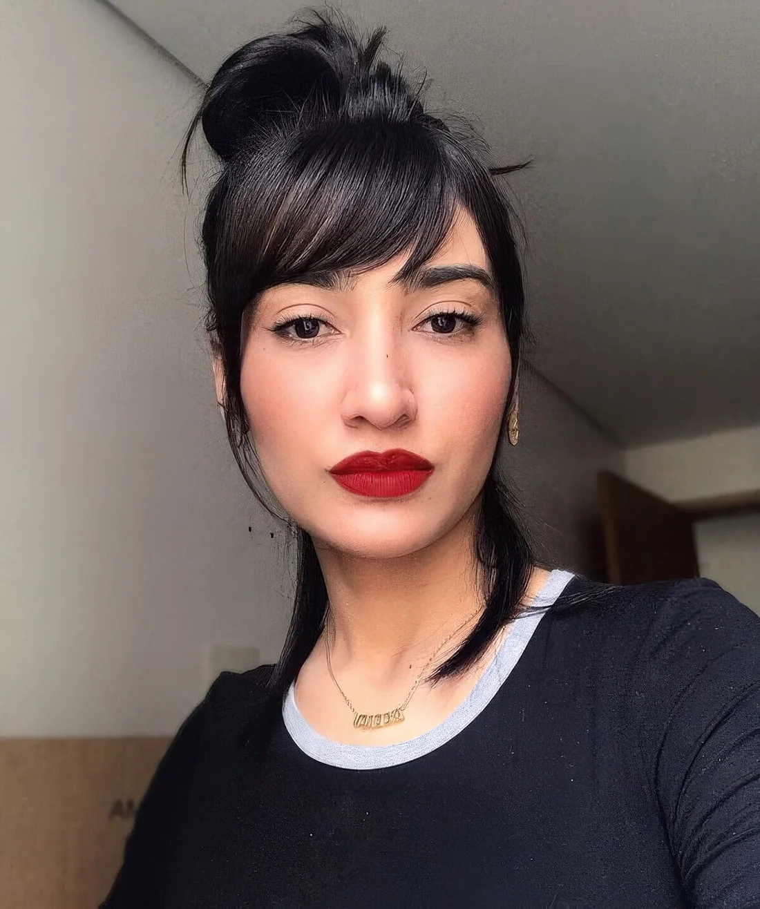 Photo showing messy side knot with side bangs, with the hairstyle clearly visible.