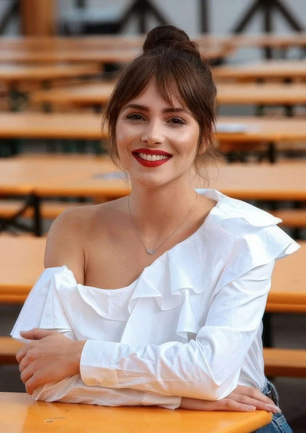 Top knot with bottleneck and curtain bangs.