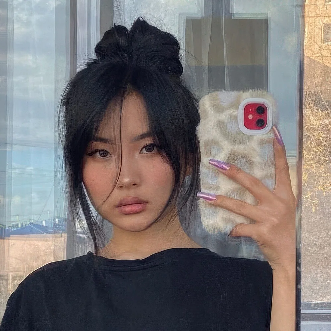 Wrapped top knot with long curtain bangs.