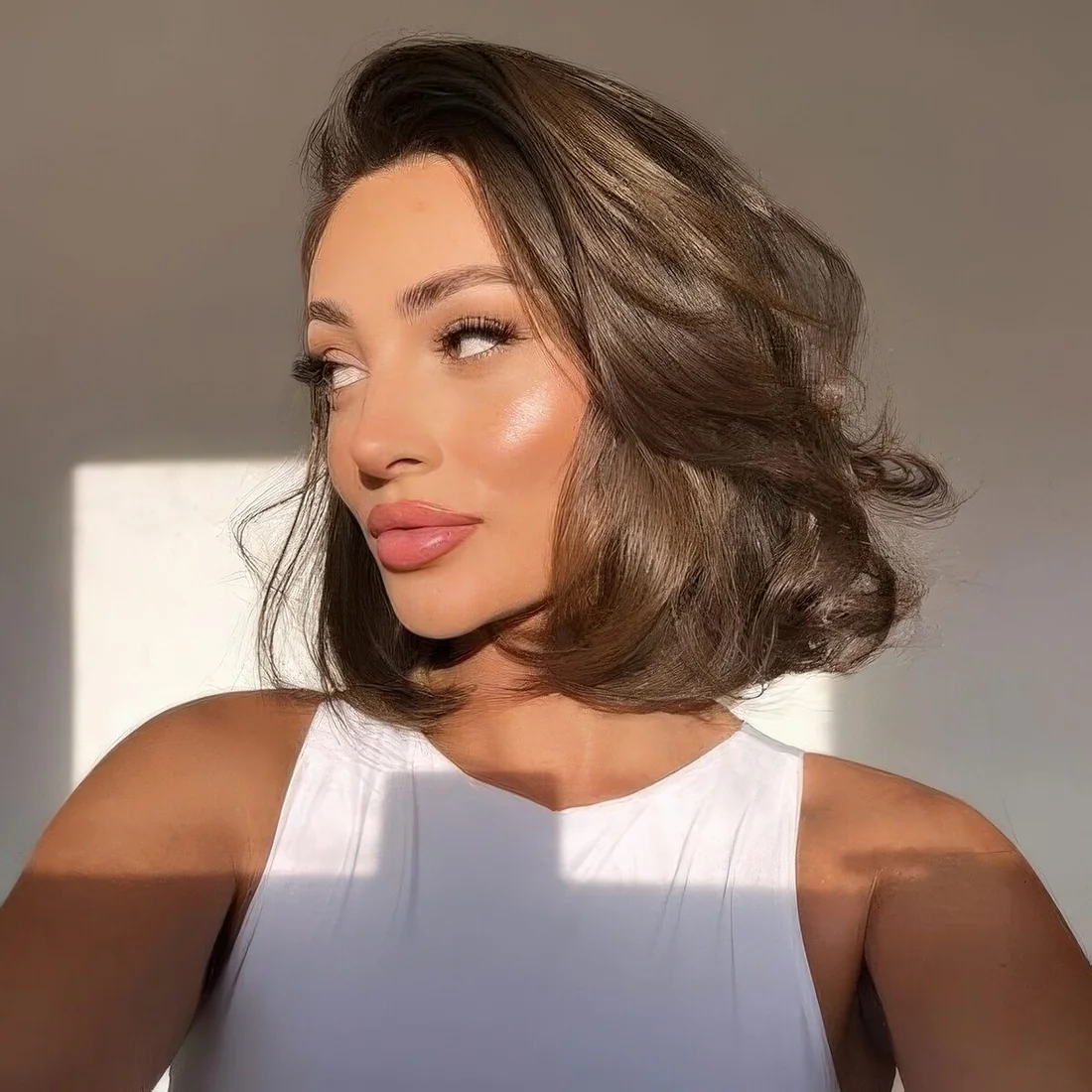 Photo showing glossy rich brown butterfly bob, with the hairstyle clearly visible.