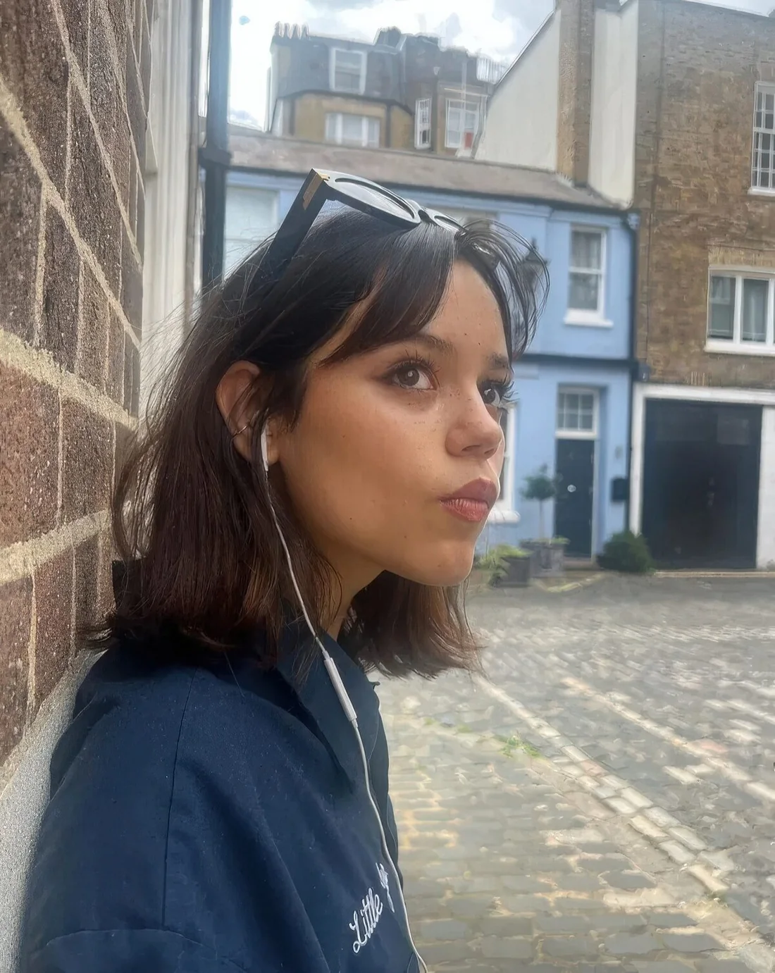 Messy long butterfly bob in dark brunette and with curtain bangs.