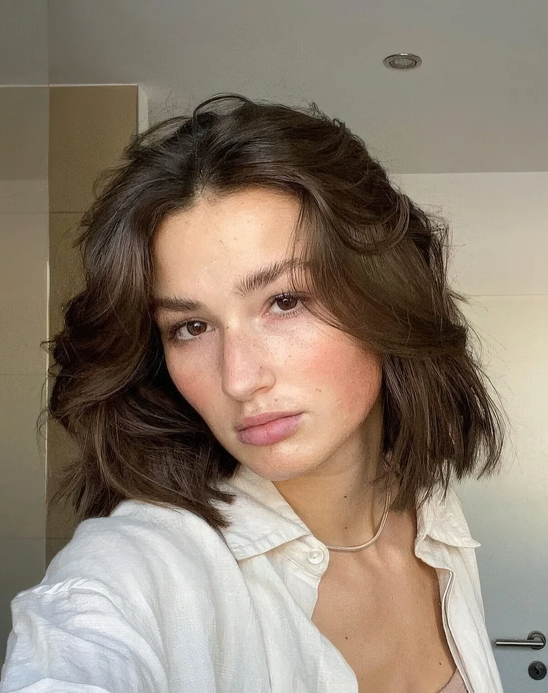 Midi brown butterfly bob with accented layers.