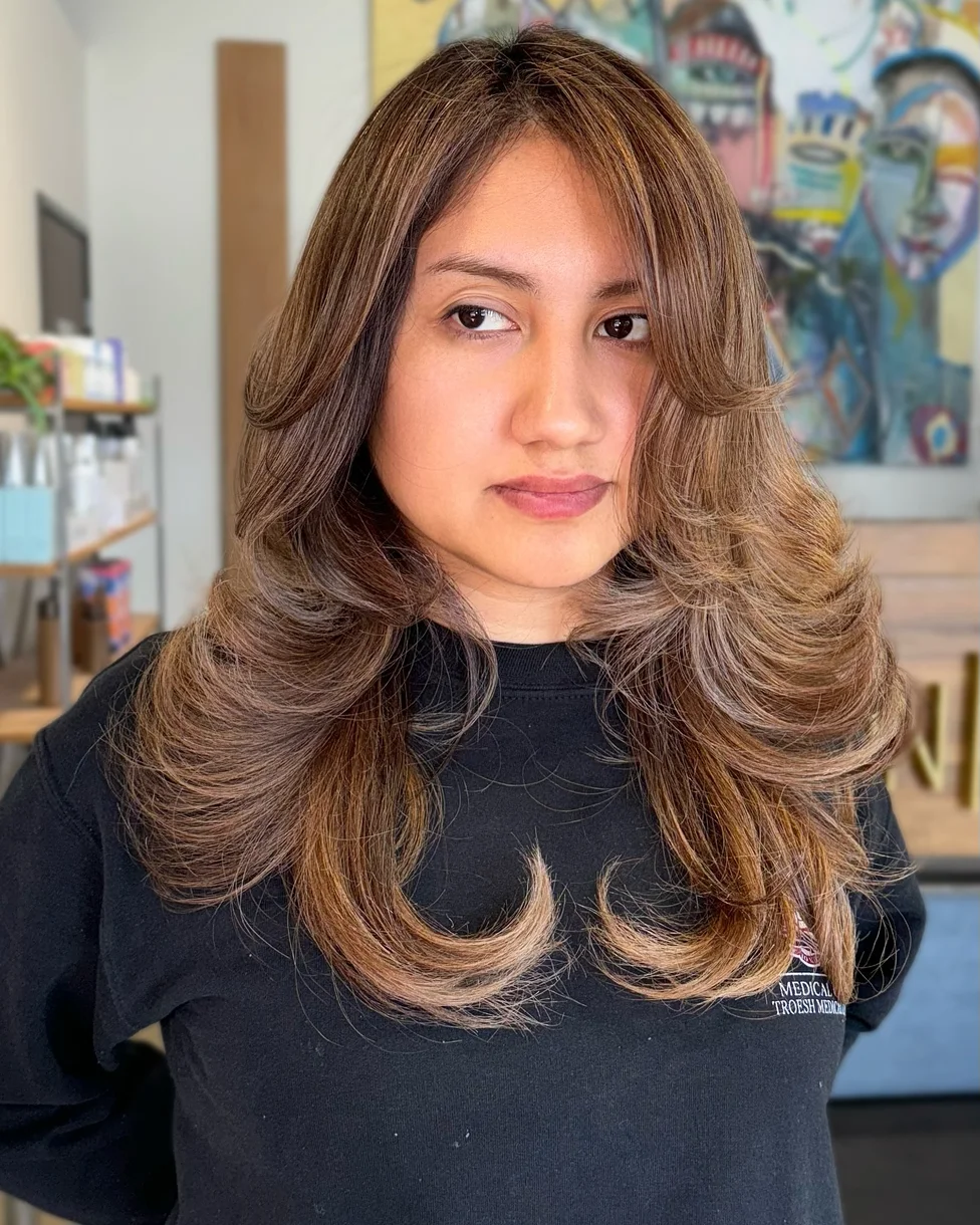 chest wavy mocha layers with curtain fringe shown as a butterfly haircut long hairs idea