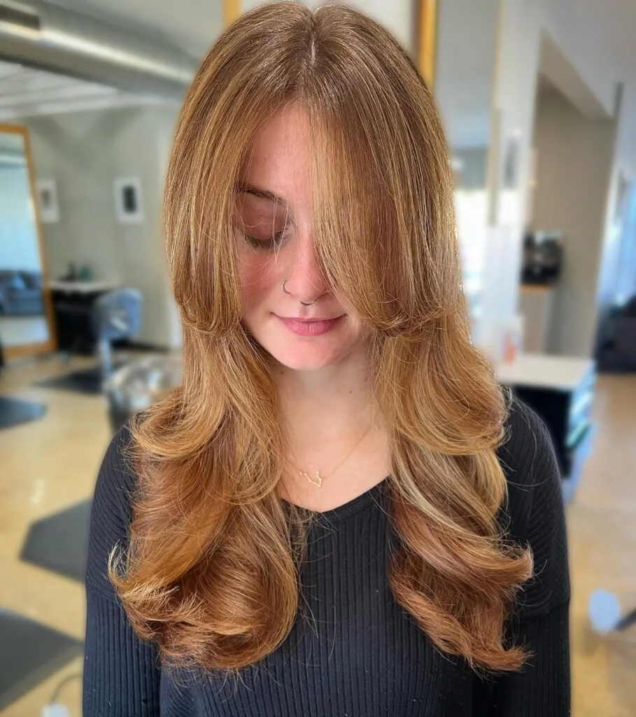 chest wavy red layers with curtain fringe shown as a butterfly haircut long hairs idea