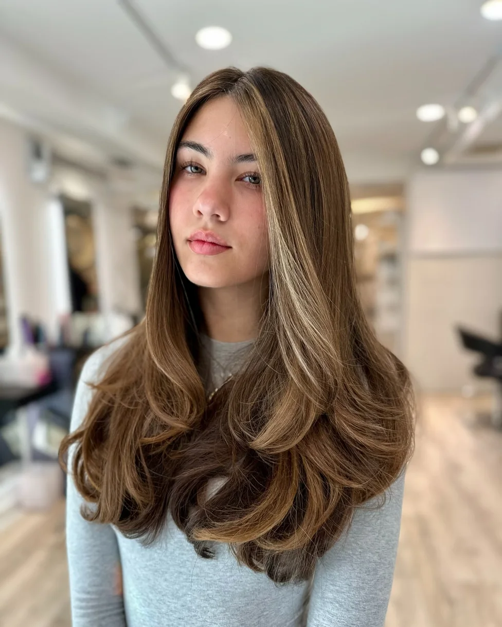 chest wavy honey layers shown as a butterfly haircut long hairs idea, featuring glossy finish