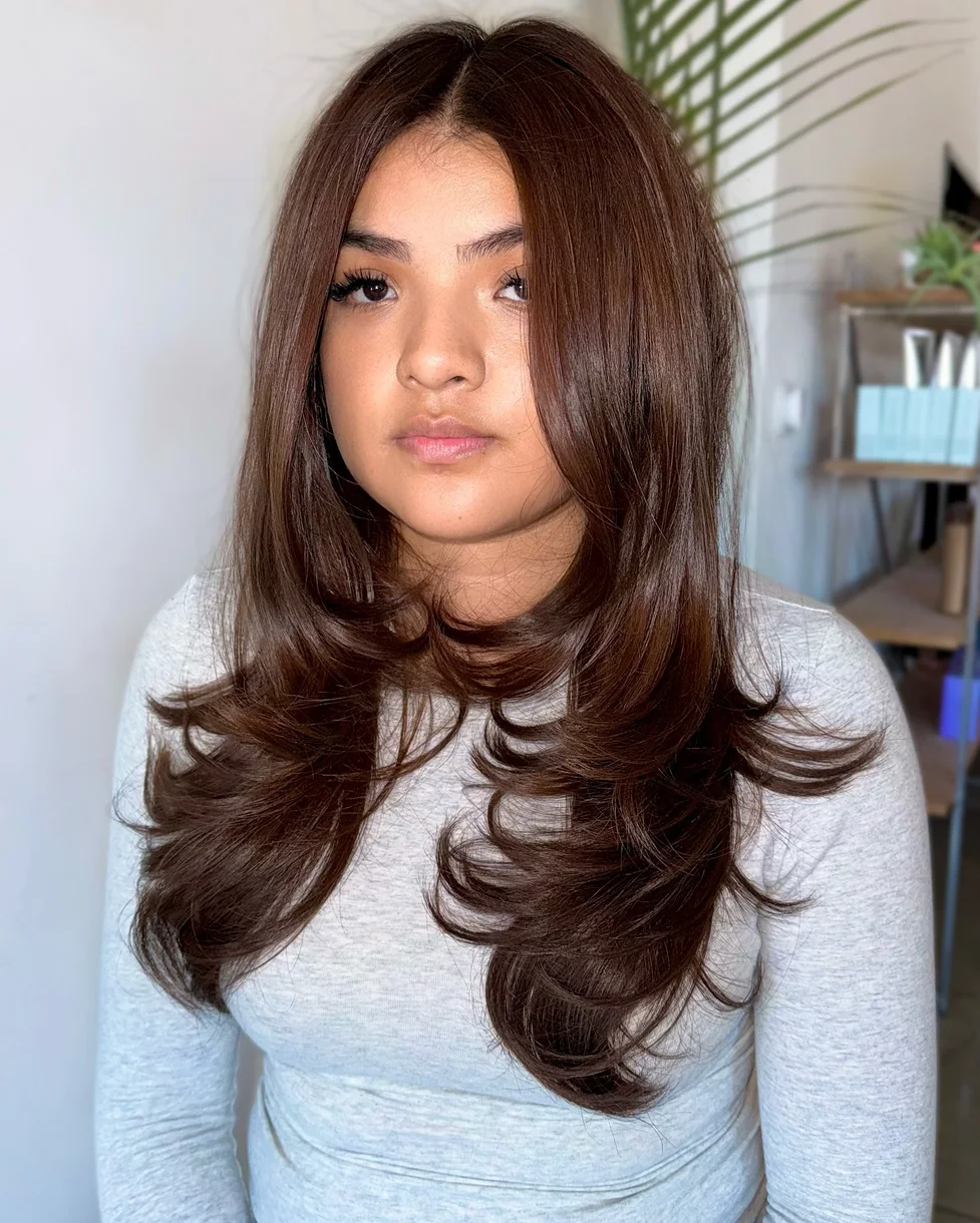 chest wavy honey layers shown as a butterfly haircut long hairs idea, featuring volume through the ends