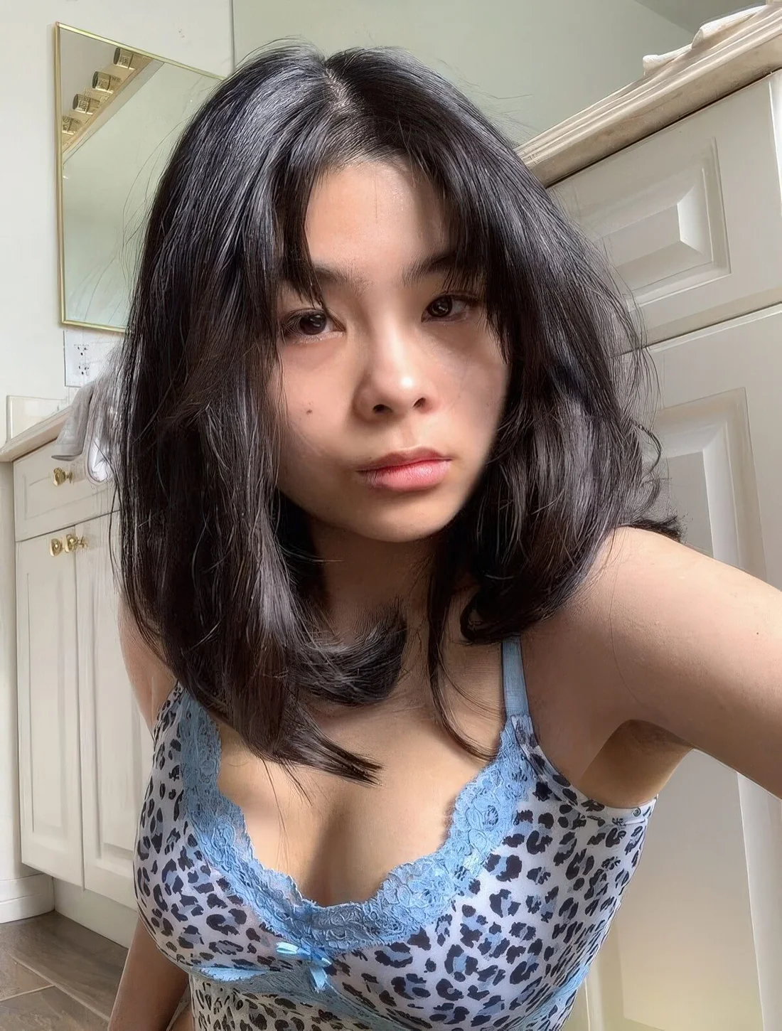 Medium butterfly haircut with short curtain bangs and a lot of volume.