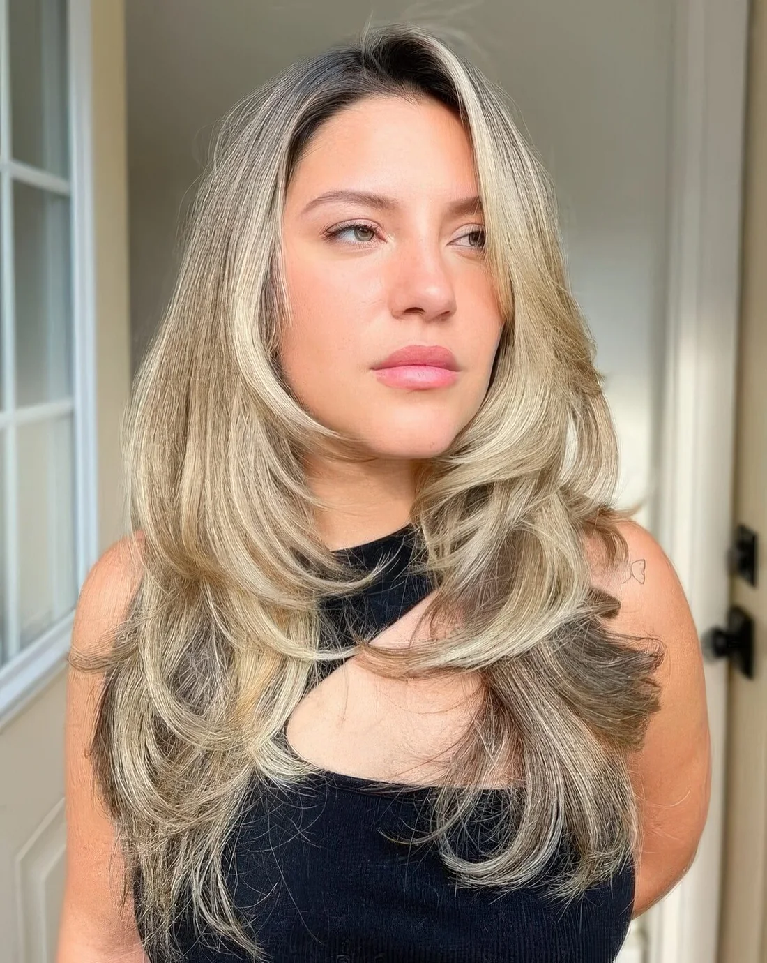 Bronde to blonde long butterfly haircut with wavy ends and a bit of volume.
