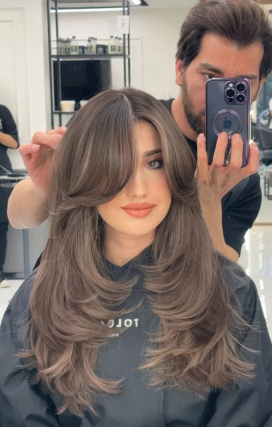 Jaw doppring long butterfly brunette hairstyle with long curtain bangs.