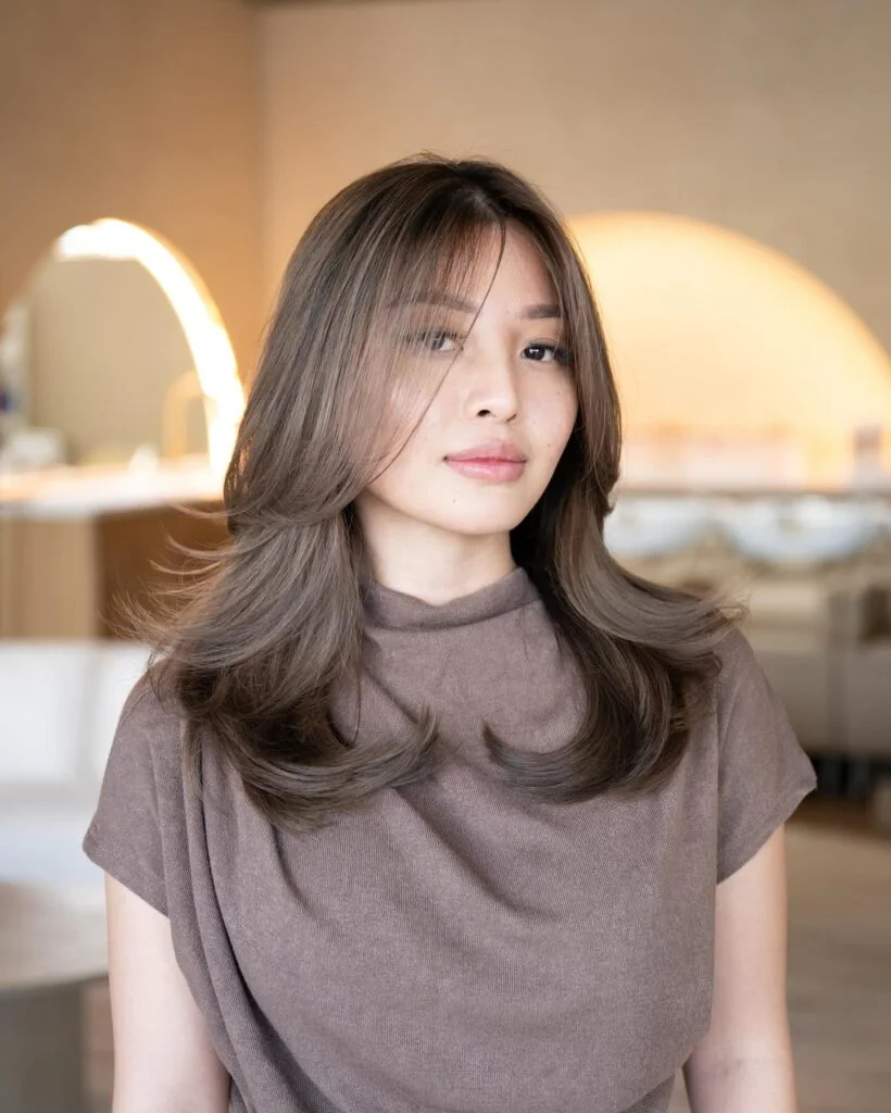 shoulder straight brunette layers with curtain fringe shown as a butterfly haircuts with bangs idea