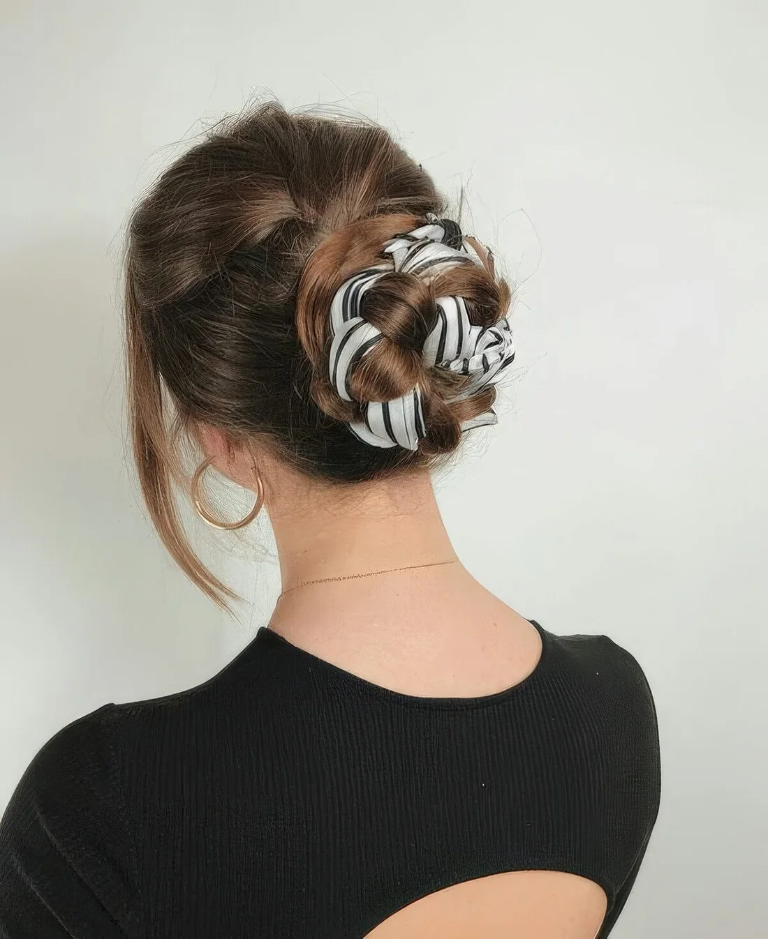 Creative midi bun with a head scarf interwoven, a messy top and face-framing hair isn't just casual, it's quite chic.
