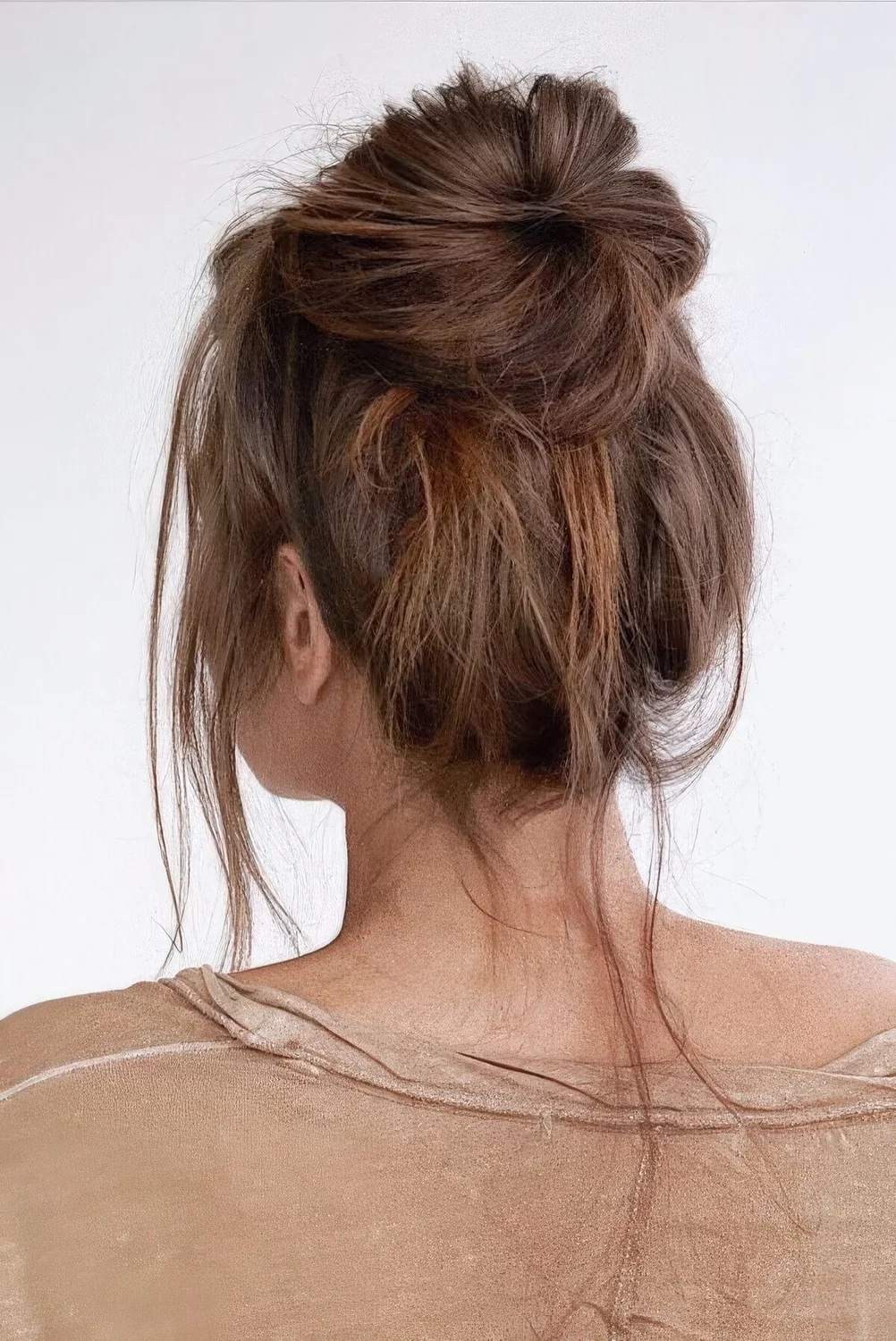 Messy and textural ballerina top knot with some hair down.