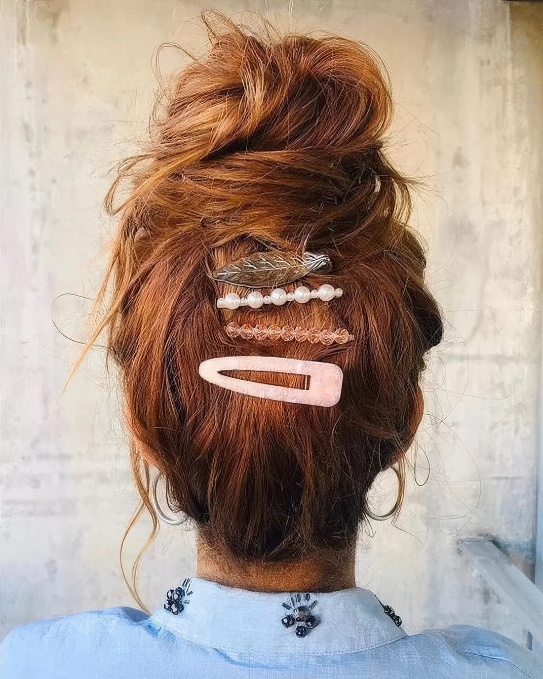 Messy top knot with a row of hair clips for an accent.