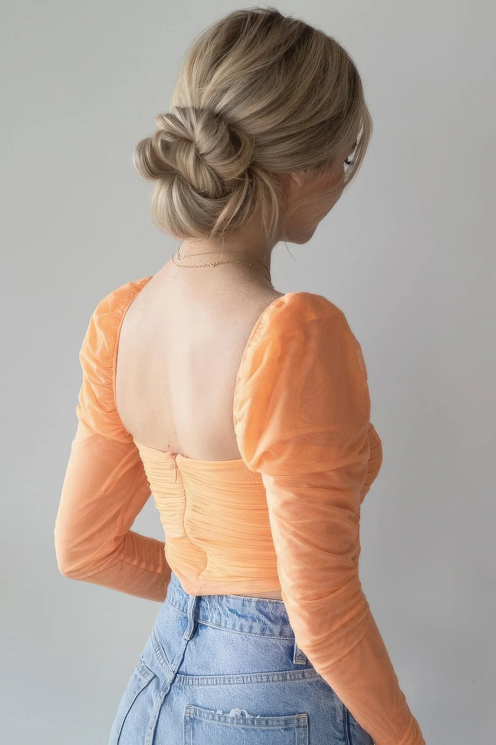 Messy wrapped low bun with a mesys and volumetric top and face-framing bangs are a hairstyle that always.